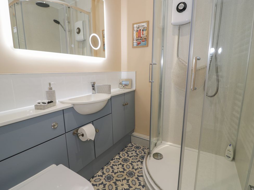 A bathroom with a sink and shower at Lan y Mor in Porthmadog