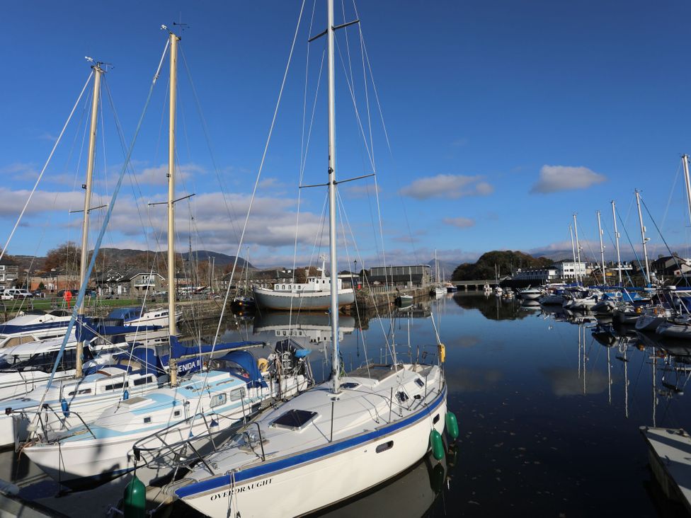 A marina with sailboats and water reflections at Lan y Mor in Porthmadog