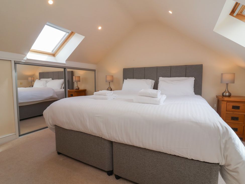 A bedroom with a double bed and bedside tables at The Old Byres in Washford near Watchet