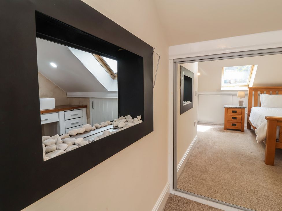 A bedroom with a bed and nightstand at The Old Byres in Washford near Watchet