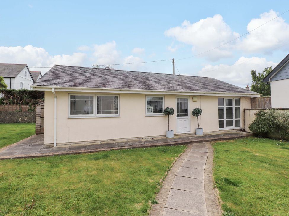 A bungalow with a pathway and garden at The Bungalow Morfa Nefyn near Pwllheli