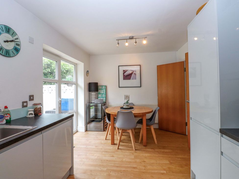 A kitchen with a dining table and chairs at The Bungalow in Morfa Nefyn near Pwllheli