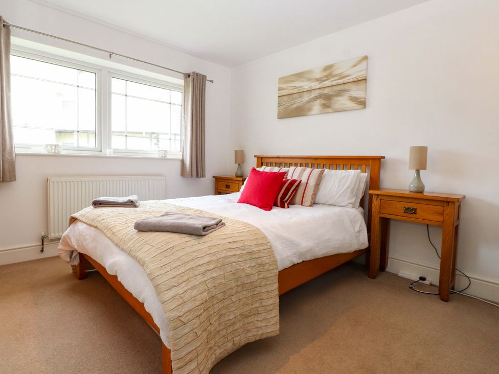 A bedroom with a bed and bedside tables at The Bungalow in Morfa Nefyn near Pwllheli