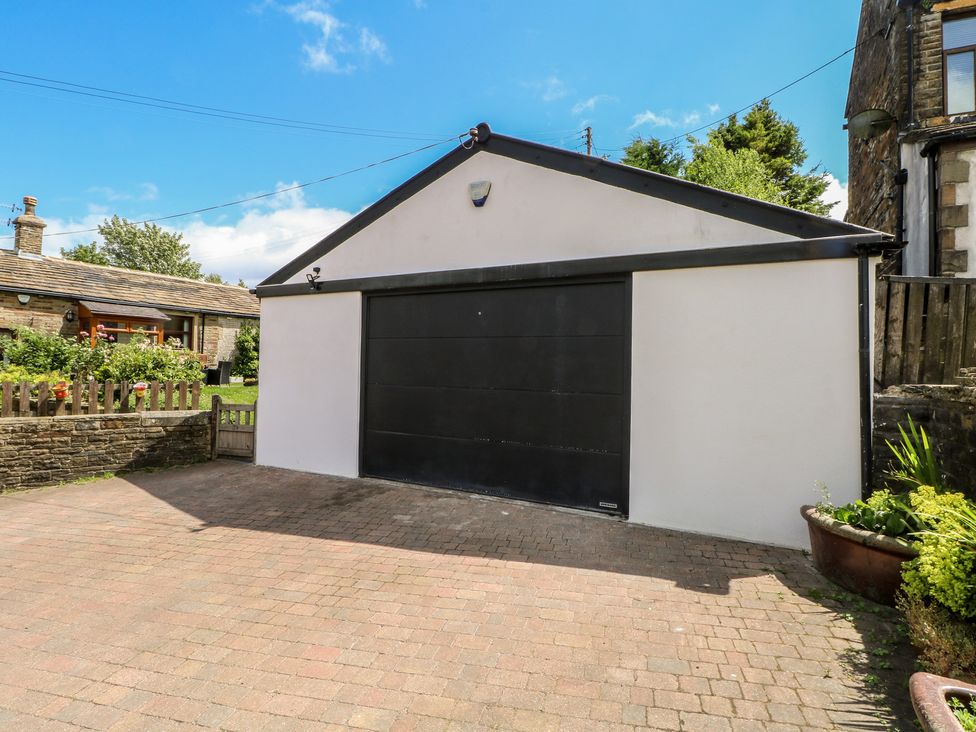 A garage with a black door at West End House in Thornton, West Yorkshire