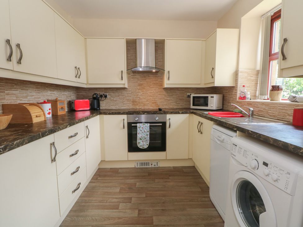 A kitchen with appliances and cabinetry at West End House in Thornton, West Yorkshire