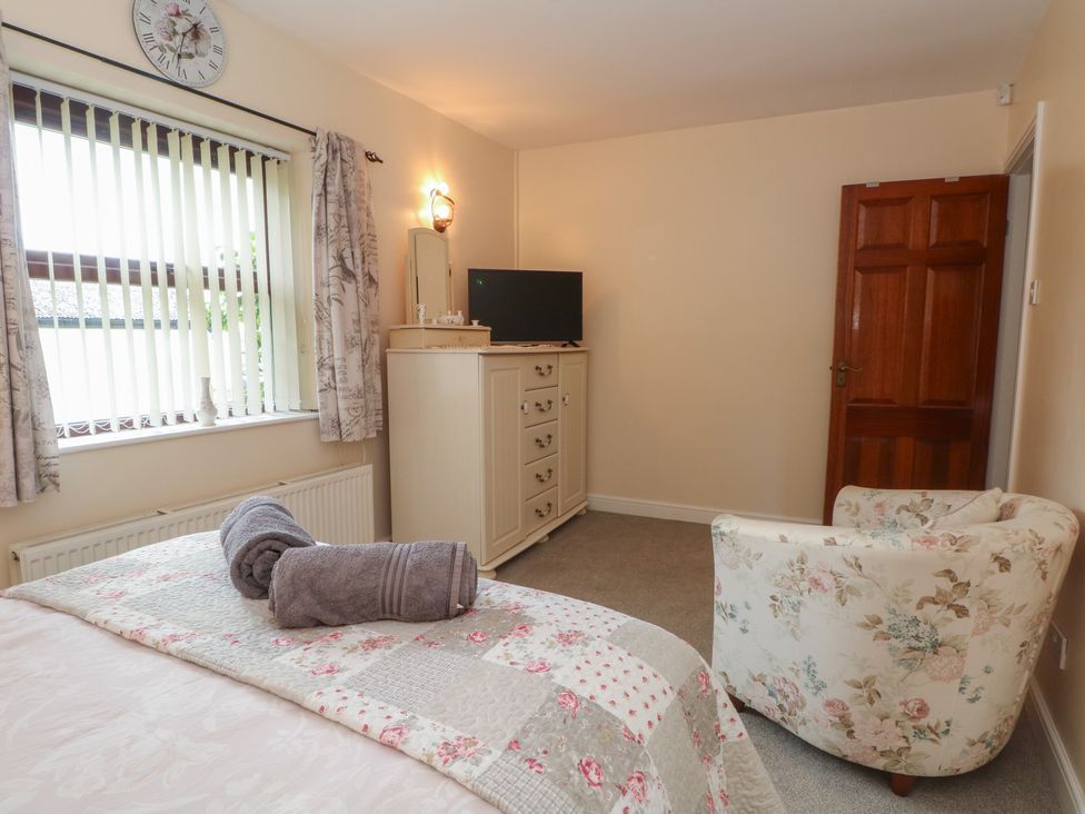 A bedroom with a bed and chest of drawers at West End House in Thornton, West Yorkshire