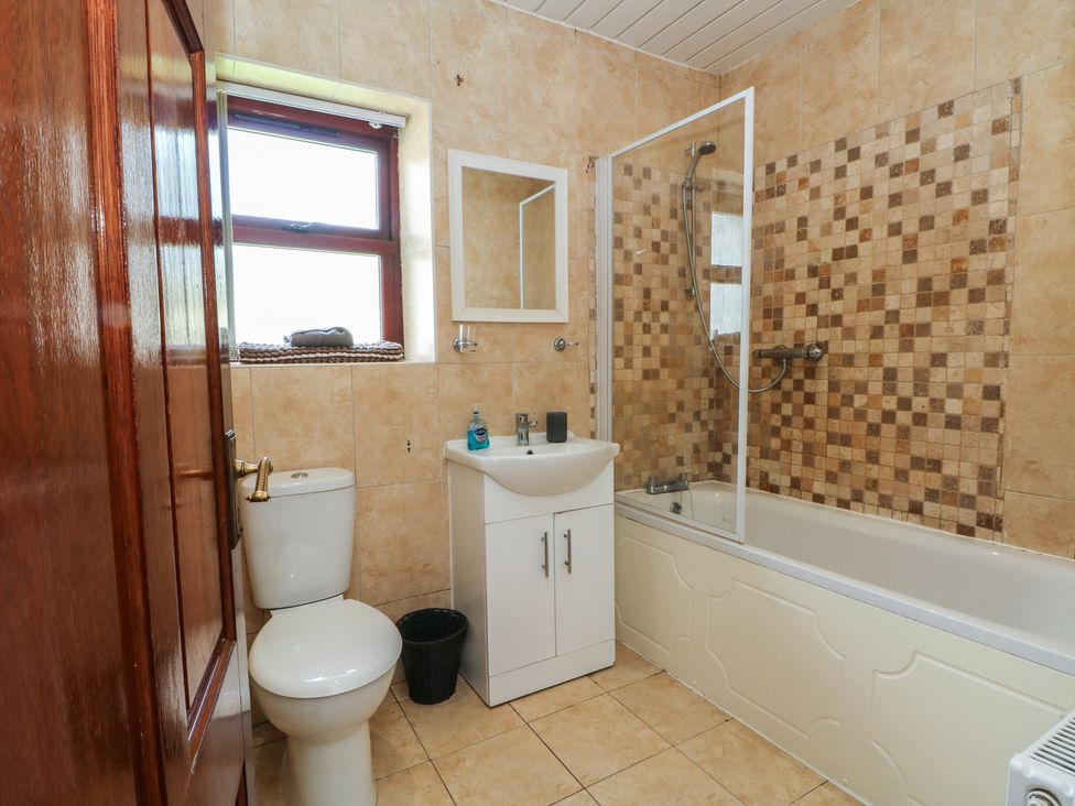 A bathroom with a toilet, sink, and bathtub at West End House Thornton, West Yorkshire