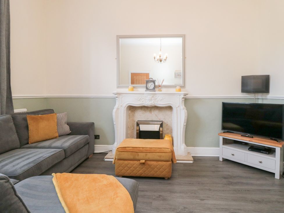 A living room with a sofa and television at Roseberry House in Guisborough