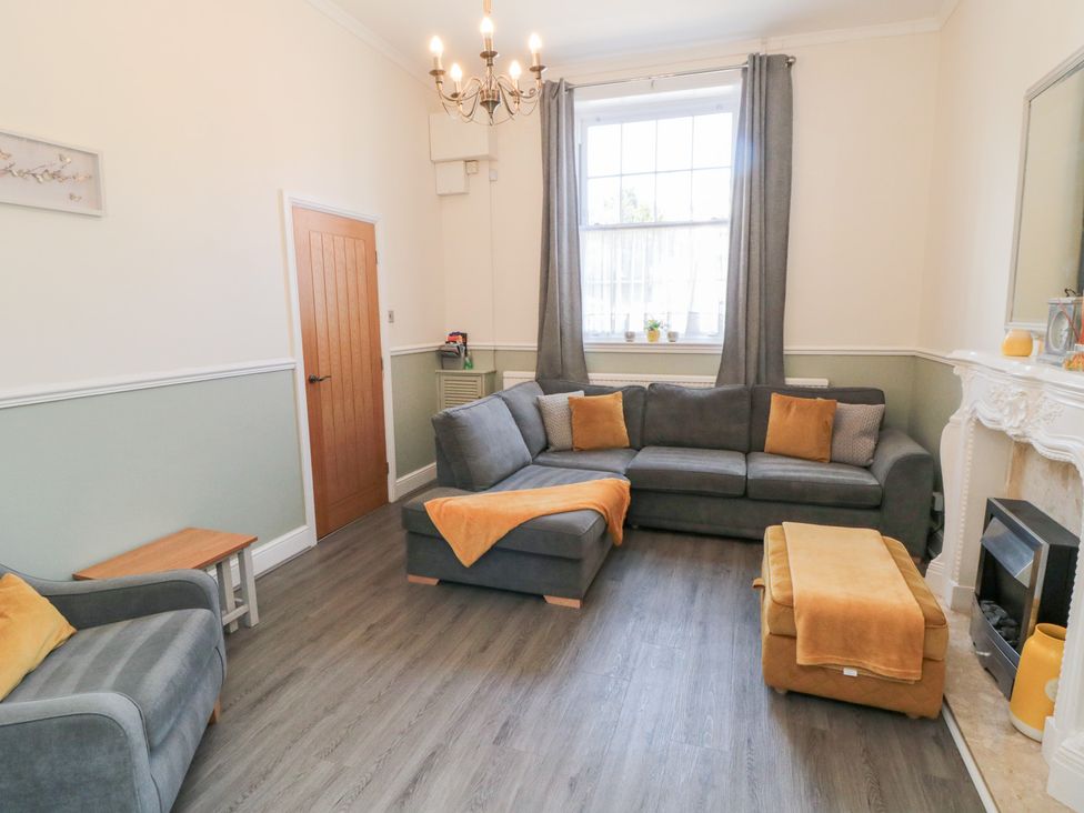 A living room with a sofa and fireplace at Roseberry House in Guisborough