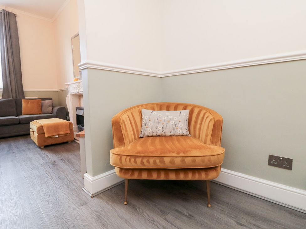 A living room with a corner armchair and sofa at Roseberry House in Guisborough