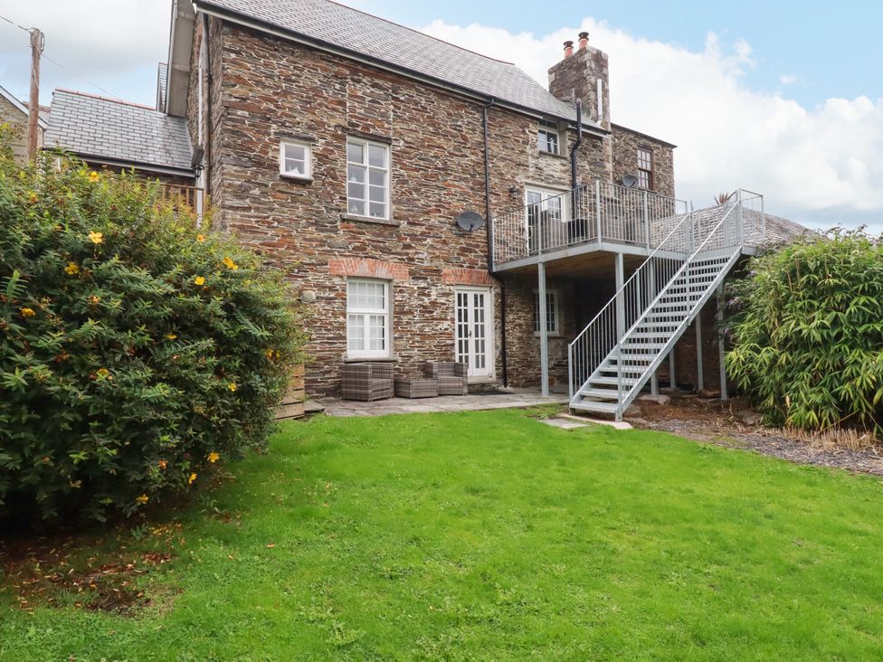 An outdoor view of a building with stairs and garden at Tower House in Boscastle