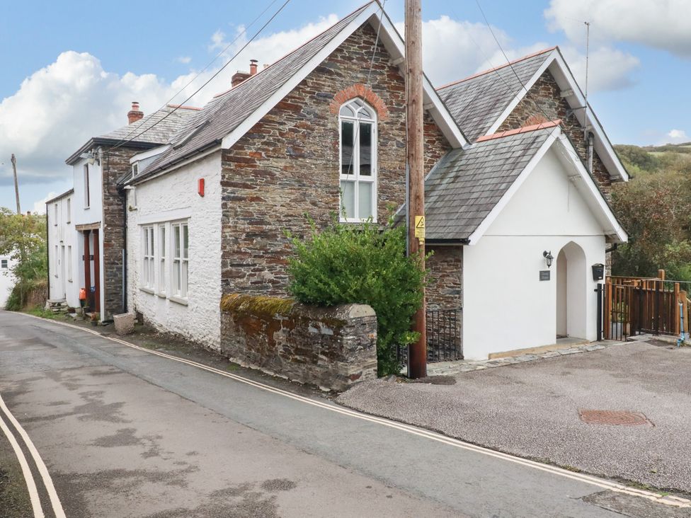 A house with a stone exterior and windows at Tower House in Boscastle