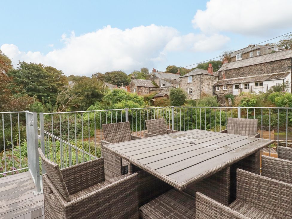 A dining table with chairs in an outdoor area at Tower House in Boscastle