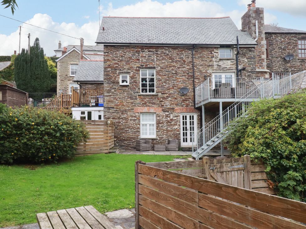 A stone house with garden and decking area at Tower House in Boscastle