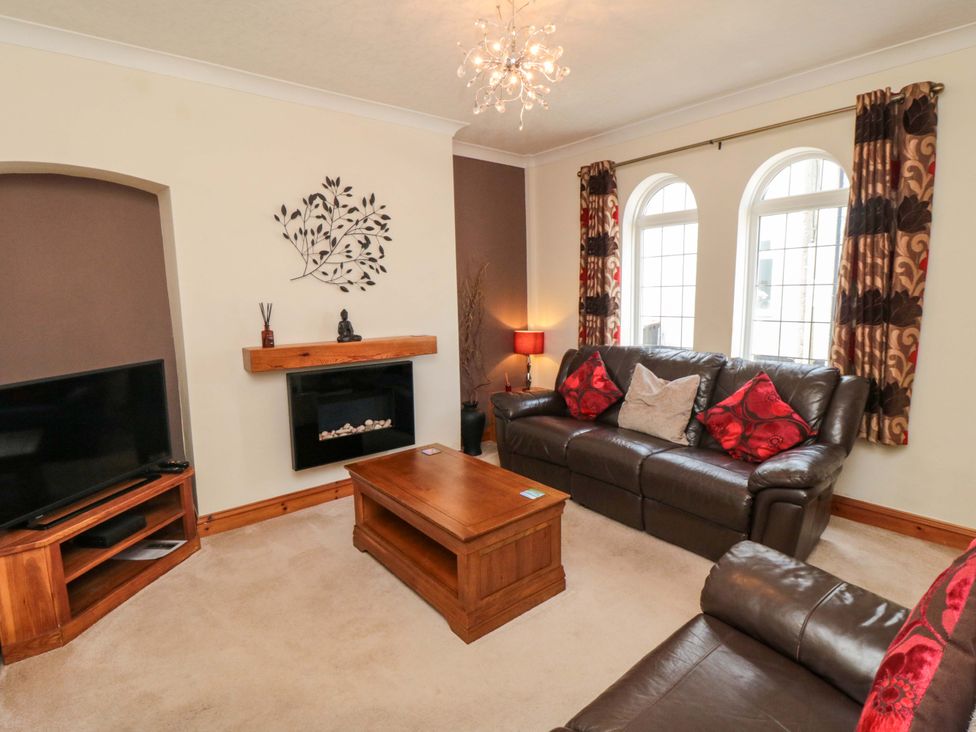 A living room with a sofa and coffee table at Sands End Cottage in Marske-by-the-Sea