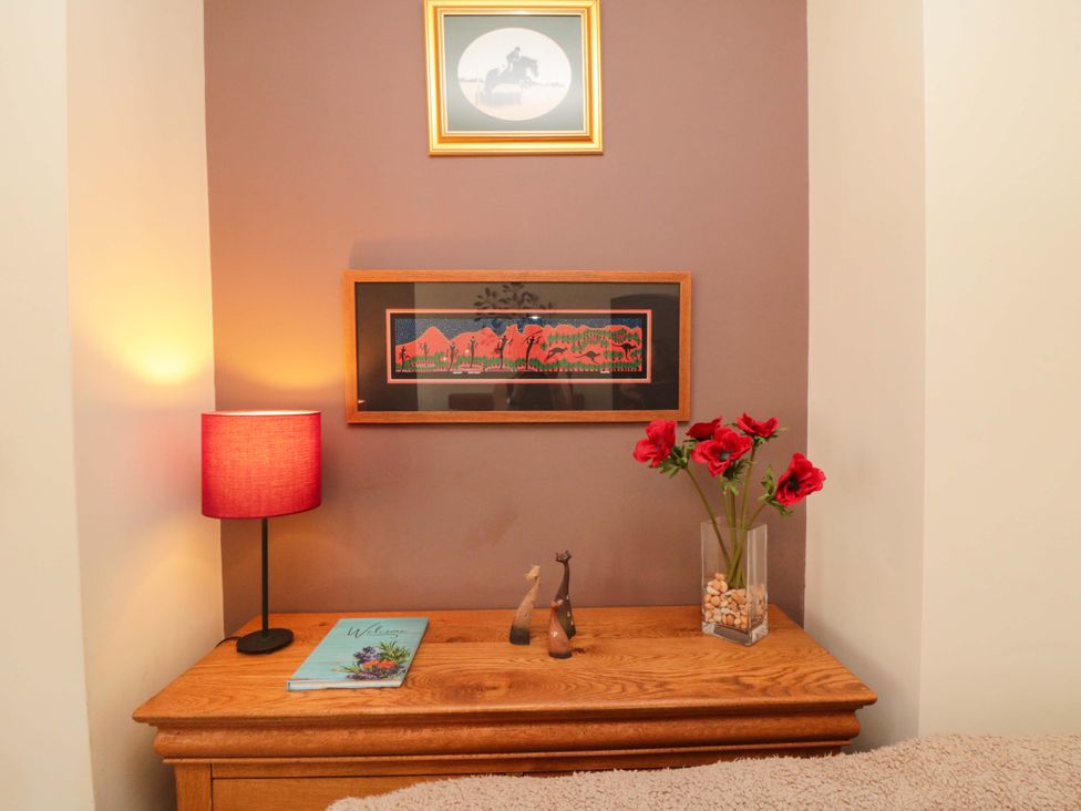 A bedroom with a lamp and decorative items at Sands End Cottage in Marske-by-the-Sea