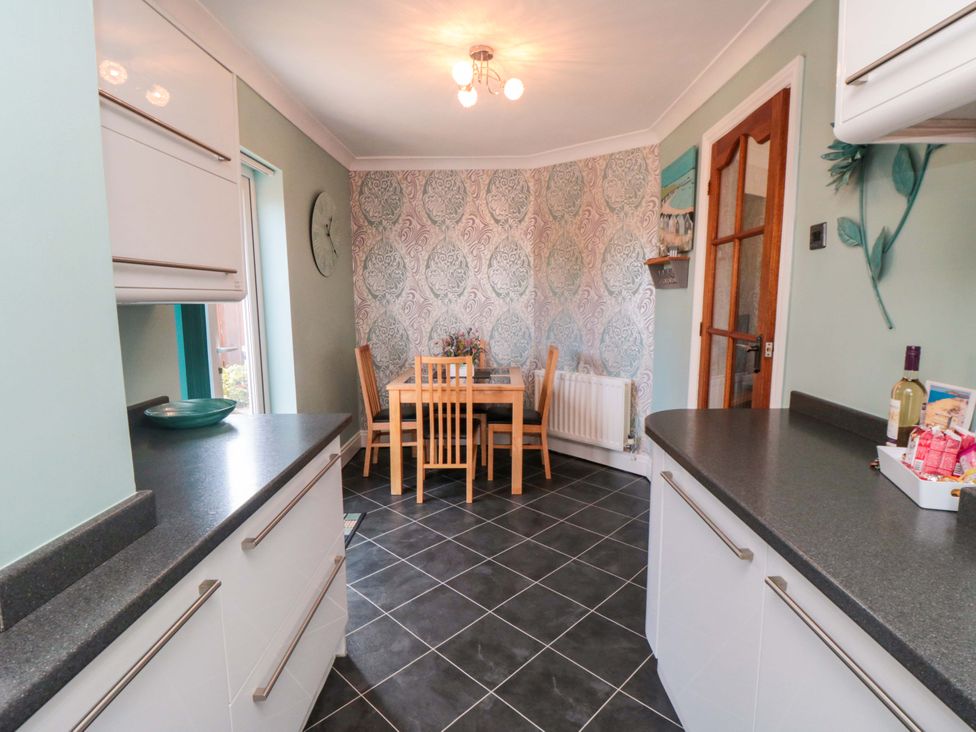 A kitchen with a table and chairs at Sands End Cottage in Marske-by-the-Sea