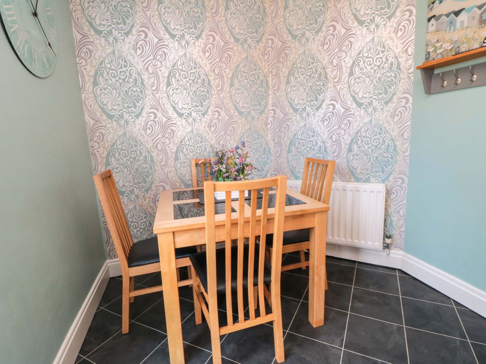 A dining room with a table and chairs at Sands End Cottage in Marske-by-the-Sea