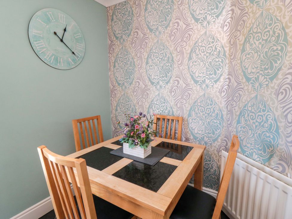 A dining room with a table and chairs at Sands End Cottage in Marske-by-the-Sea