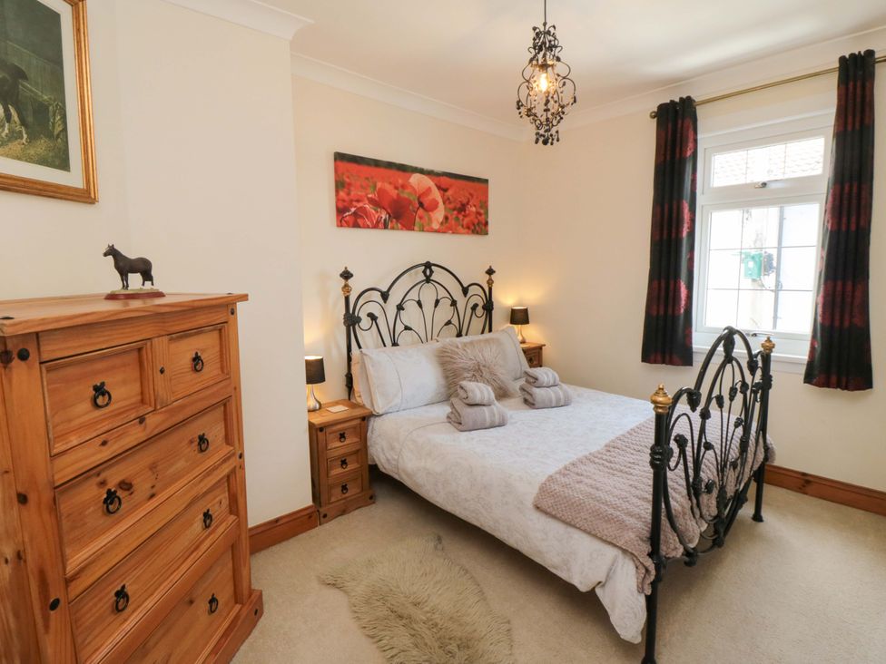 A bedroom with a bed and chest of drawers at Sands End Cottage, Marske-by-the-Sea