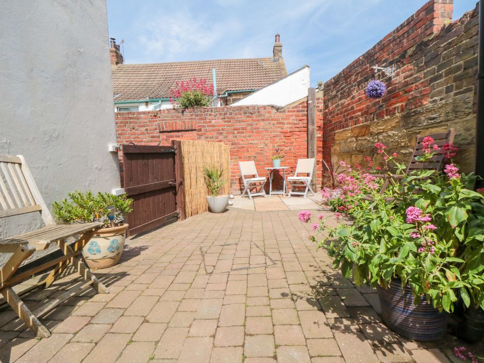 A garden with a paved area and seating at Sands End Cottage Marske-by-the-Sea