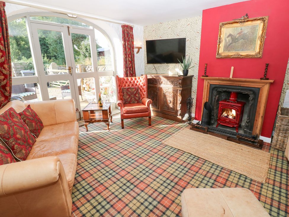A living room with a fireplace and seating at 2 The Coach House in Romaldkirk near Middleton-in-Teesdale