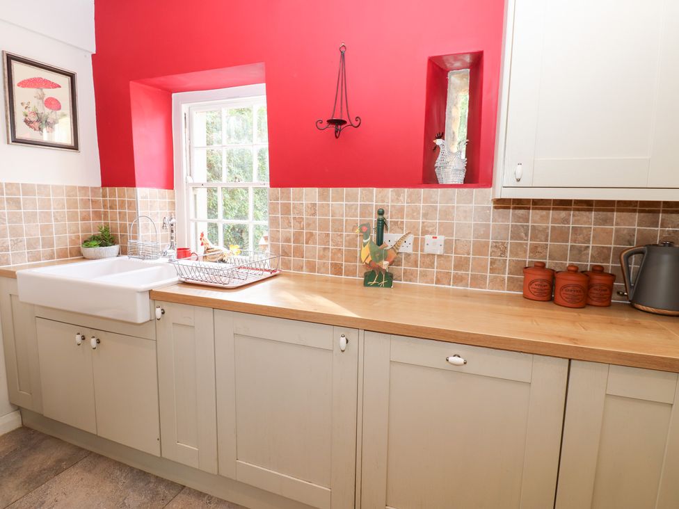 A kitchen with a sink and cabinets at 2 The Coach House in Romaldkirk near Middleton-in-Teesdale