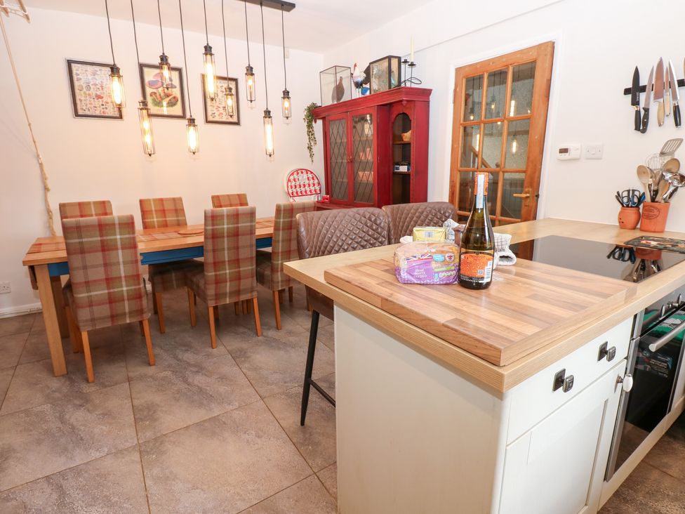A kitchen with a dining area and a kitchen island at 2 The Coach House Romaldkirk near Middleton-in-Teesdale