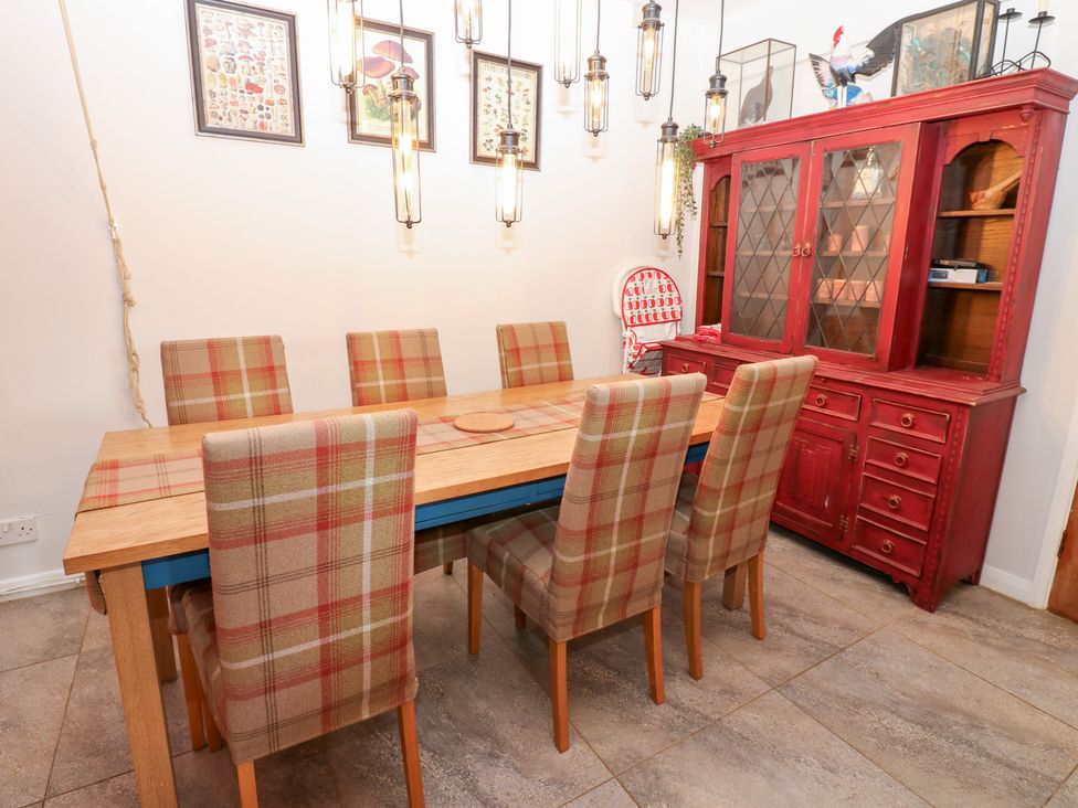 A dining room with a wooden table and chairs at 2 The Coach House in Romaldkirk near Middleton-in-Teesdale