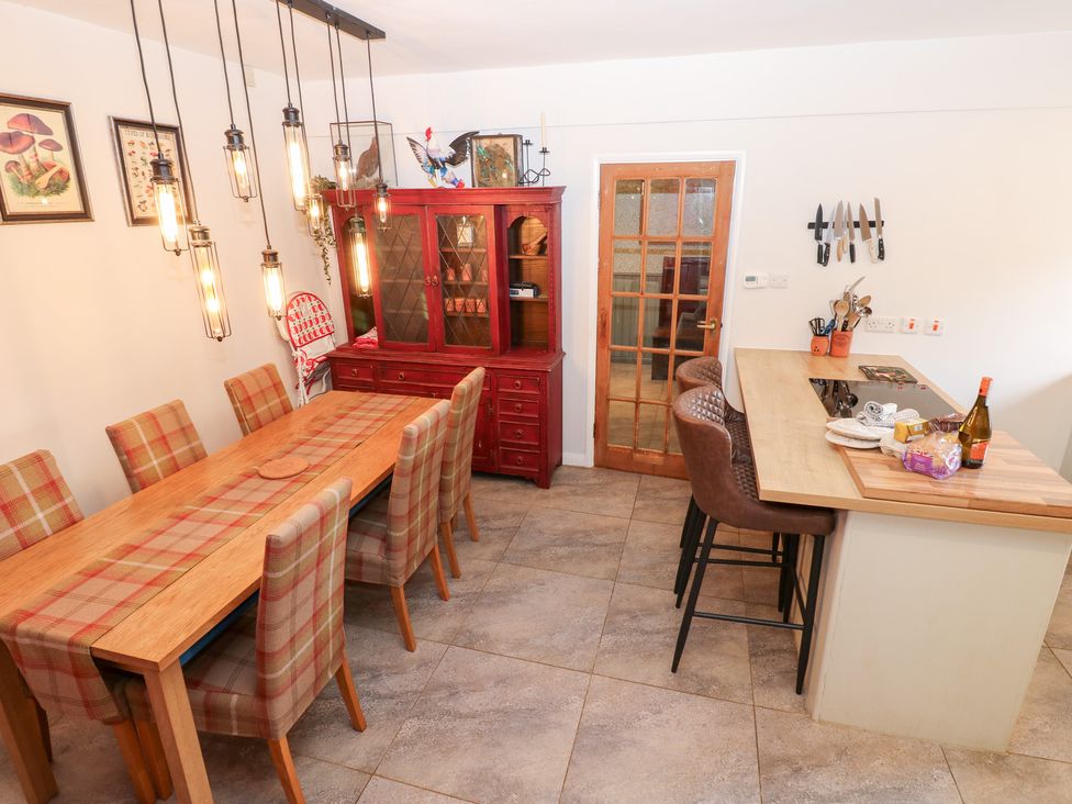 A dining room with a table and chairs at 2 The Coach House Romaldkirk near Middleton-in-Teesdale