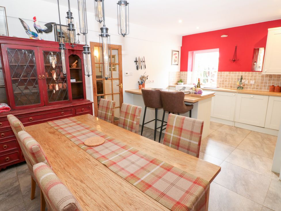 A kitchen with a dining table and sideboard at 2 The Coach House, Romaldkirk near Middleton-in-Teesdale