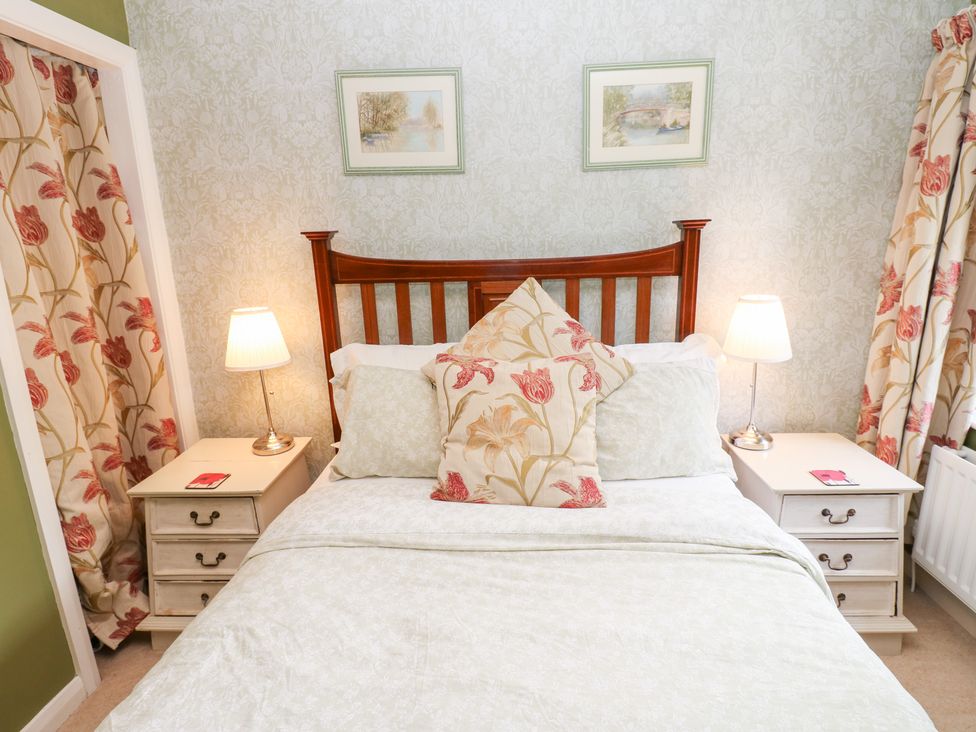 A bedroom with a bed and bedside tables at 2 The Coach House in Romaldkirk near Middleton-in-Teesdale