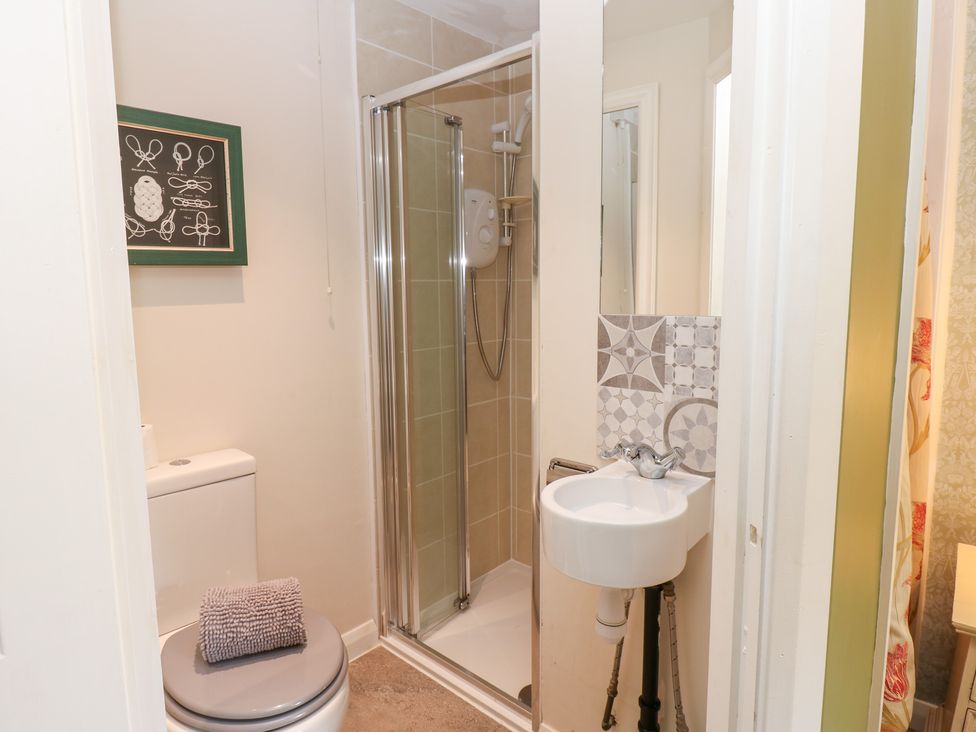A bathroom with a shower, toilet, and hand basin at 2 The Coach House in Romaldkirk near Middleton-in-Teesdale