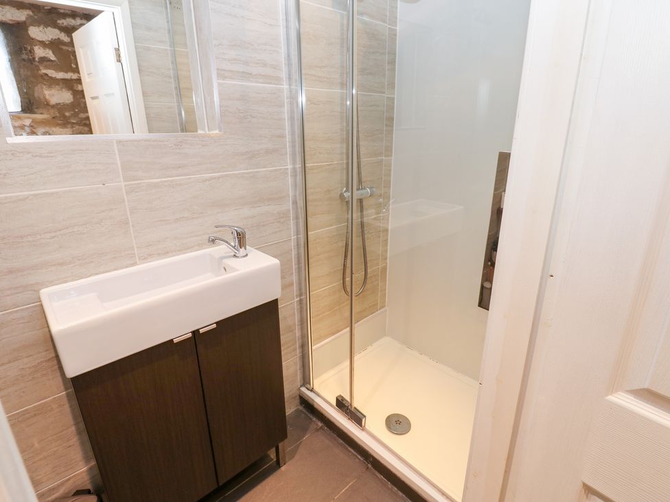 A bathroom featuring a sink, cabinet, and shower at 2 The Coach House Romaldkirk near Middleton-in-Teesdale