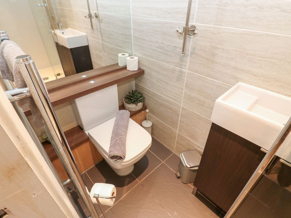 A bathroom with a toilet, hand basin, and shower at 2 The Coach House Romaldkirk near Middleton-in-Teesdale
