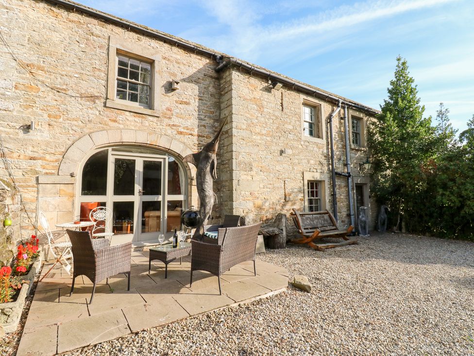 An outdoor seating area with chairs and a table at 2 The Coach House Romaldkirk near Middleton-in-Teesdale