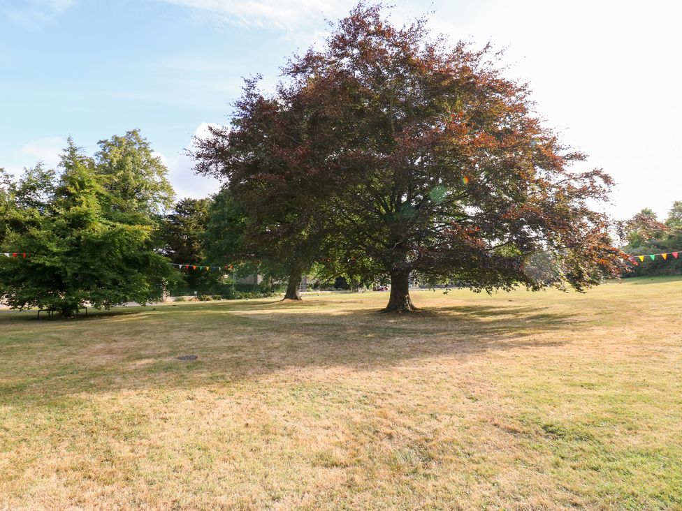 A grassy area with trees and colorful flags at 2 The Coach House Romaldkirk near Middleton-in-Teesdale