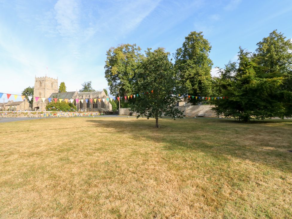 An outdoor area with a church and trees at 2 The Coach House Romaldkirk near Middleton-in-Teesdale