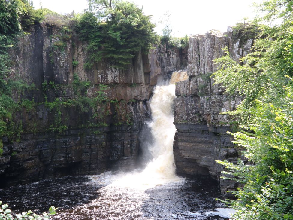 A waterfall cascading over rocks at 2 The Coach House Romaldkirk near Middleton-in-Teesdale