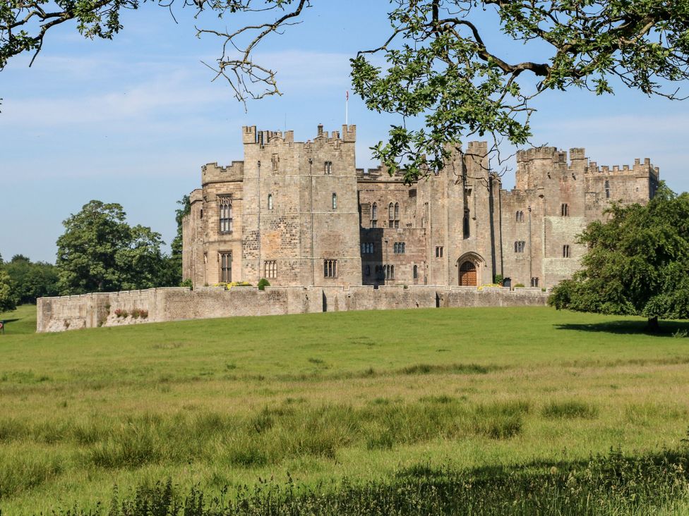 A castle surrounded by grass and trees at 2 The Coach House Romaldkirk near Middleton-in-Teesdale