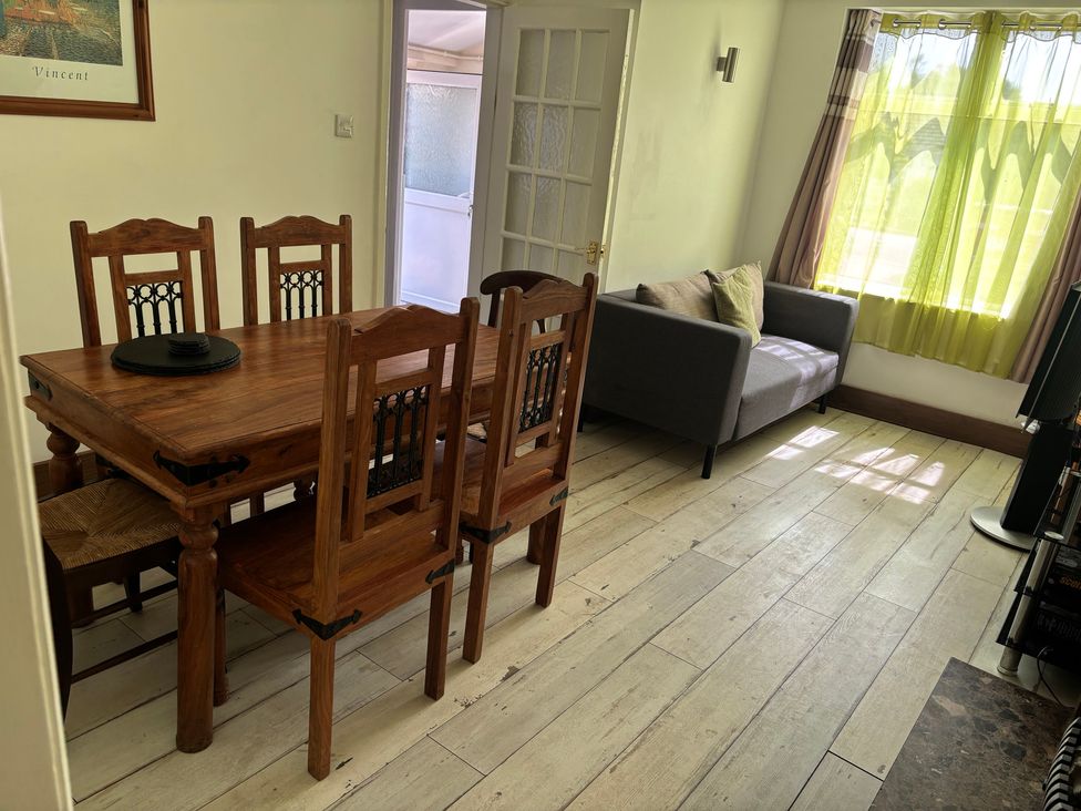 A dining room with a table and chairs at Herby's Retreat in Sutton-On-Sea