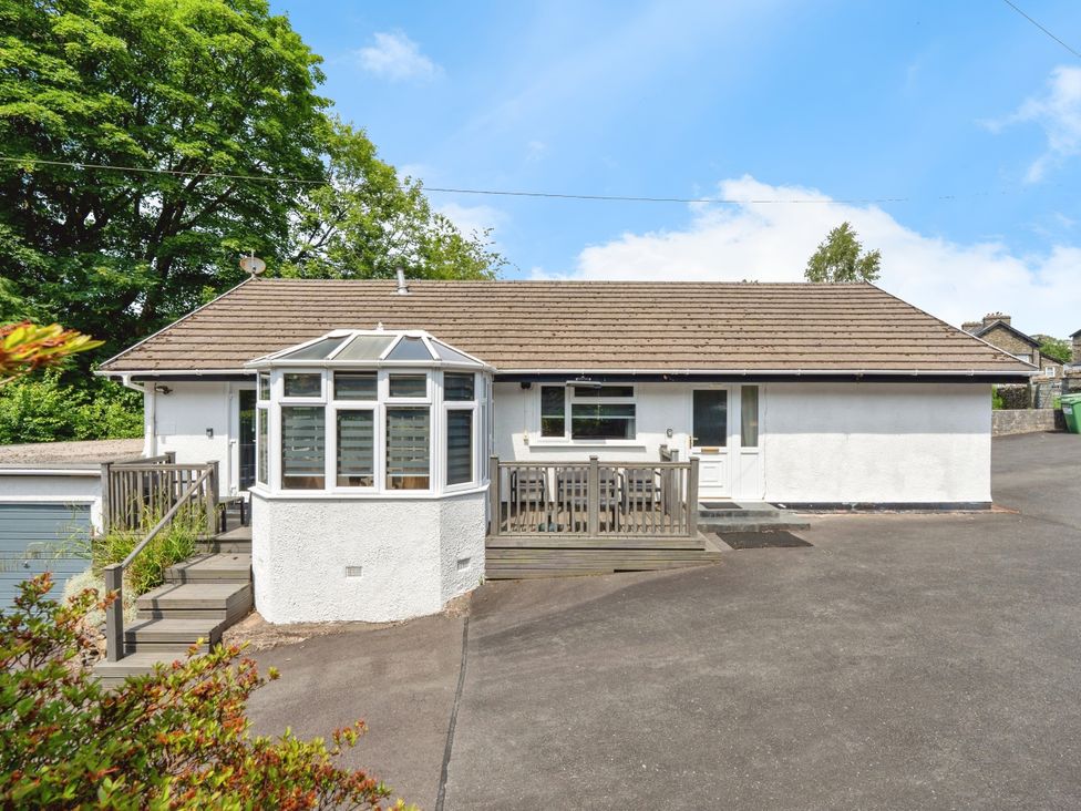 A house with a deck and steps at Mylnebeck Lodge in Bowness-on-Windermere