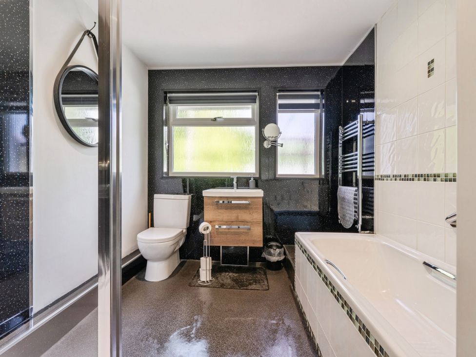 A bathroom with a sink, toilet, shower, and bathtub at Mylnebeck Lodge in Bowness-on-Windermere