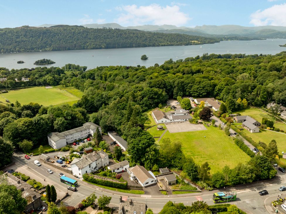 An aerial view of houses and a lake at Mylnebeck Lodge in Bowness-on-Windermere