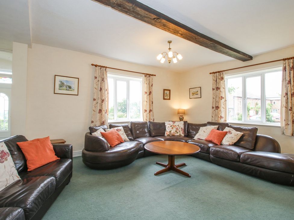 A living room with a sofa and coffee table at The Manor House at Kenwick Lodge Cockshutt near Ellesmere