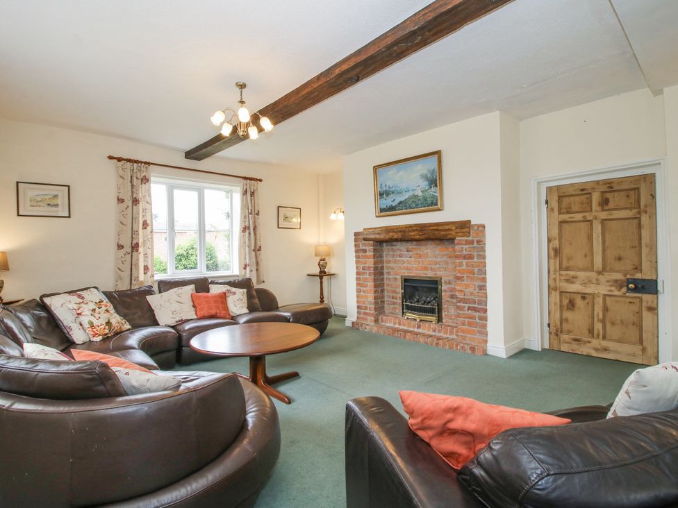 A living room with a sofa and coffee table at The Manor House at Kenwick Lodge Cockshutt near Ellesmere