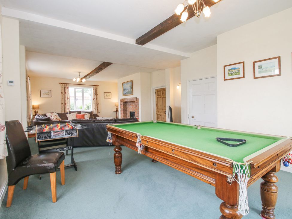 A game room with a pool table and foosball table at The Manor House at Kenwick Lodge Cockshutt near Ellesmere