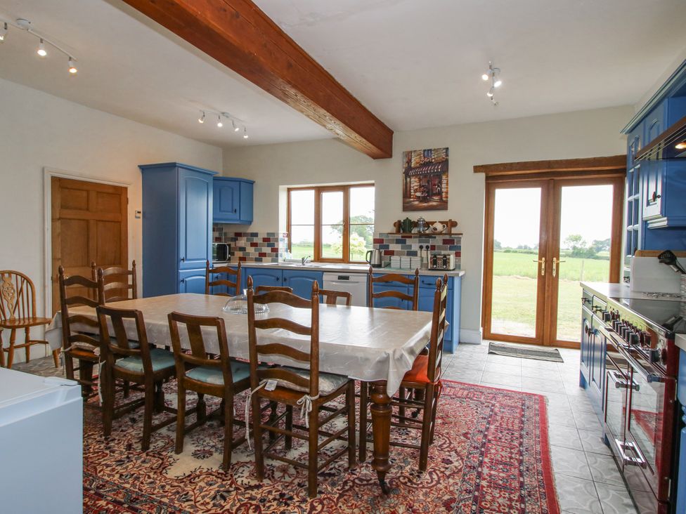 A kitchen with a dining table and chairs at The Manor House at Kenwick Lodge Cockshutt near Ellesmere