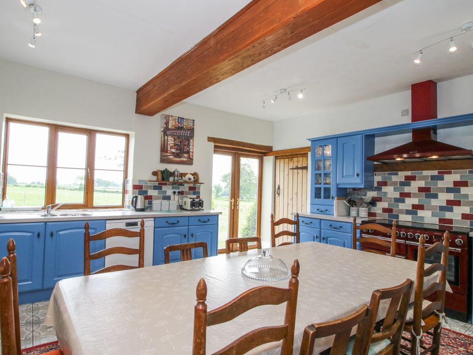 A kitchen with a table and chairs at The Manor House at Kenwick Lodge Cockshutt near Ellesmere