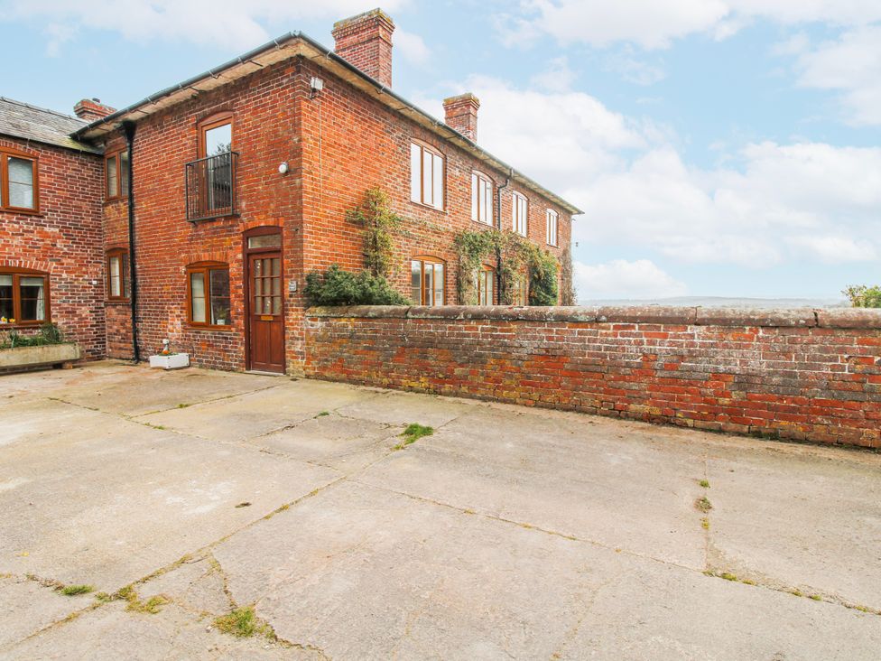 An outdoor area with a brick house and driveway at The Manor House at Kenwick Lodge Cockshutt near Ellesmere
